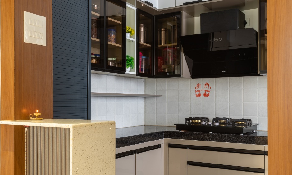 Modular kitchen interior in modern beige and black tones for the Dyaneshwar residence in Joyville Sensorium, Hinjawadi, Pune.