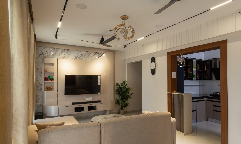 Living room design for Dyaneshwar's apartment in Joyville Sensorium, Hinjawadi, Pune, featuring a striking marble-paneled TV unit.