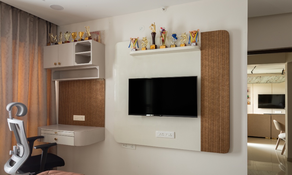 Multifunctional room design serving as a study area with a dedicated desk and wall-mounted TV
