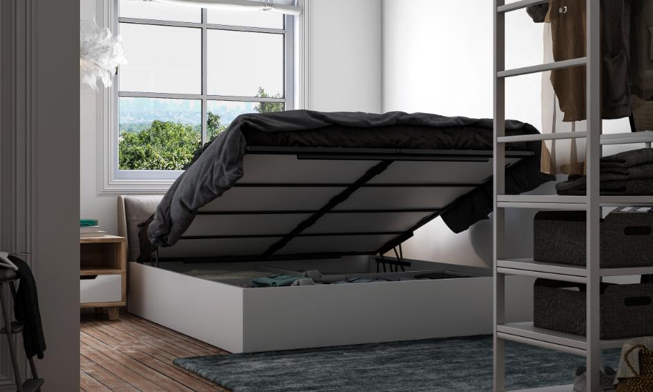 Hydraulic bed design with lift-up storage in a bright, modern bedroom with wooden flooring.