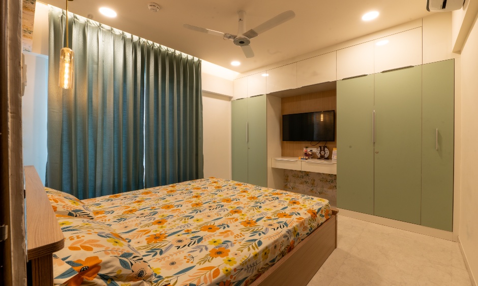 Completed projects's master bedroom with wardrobe lofts and integrated TV niche at Majestique Towers Pune