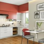 Modern kitchen design with red and white cabinets, wall art and a compact dining area