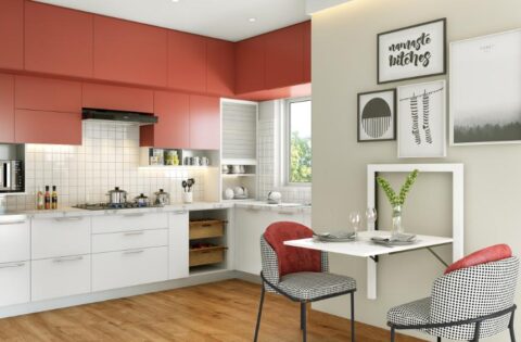 Modern kitchen design with red and white cabinets, wall art and a compact dining area
