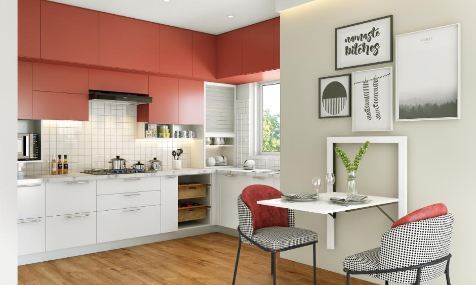 Modern kitchen design with red and white cabinets, wall art and a compact dining area