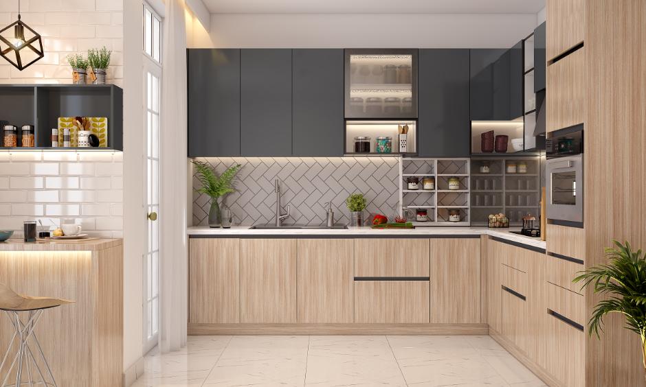 Modern modular kitchen interior design cost in Hyderabad, which has wooden cabinets, grey finishes, and built-in storage.