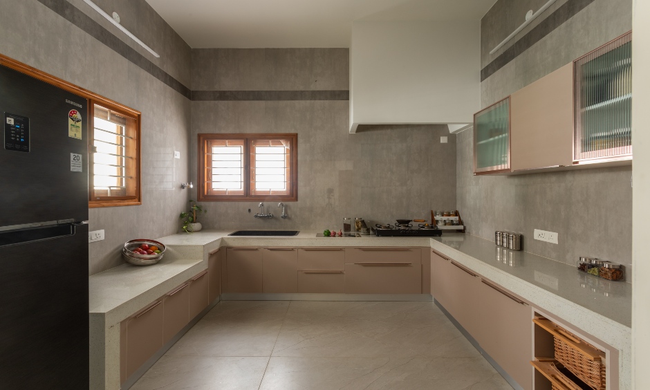 Modern taupe U-shaped kitchen with stone finishes, Vishweshwara Nagar, Coimbatore.
