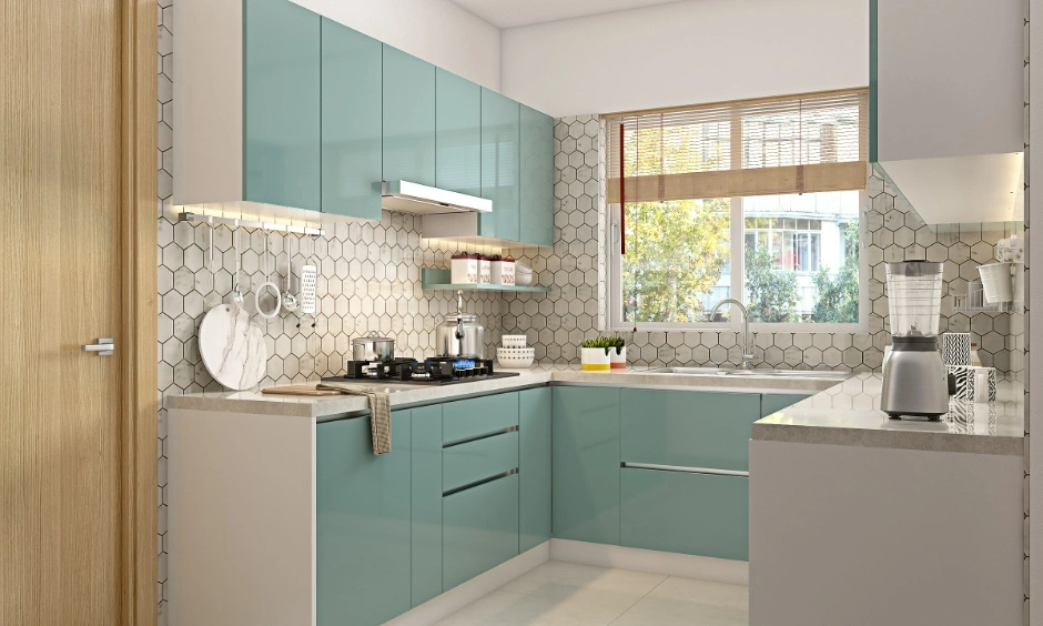 Glossy aqua cabinetry and white surfaces help reflect light throughout the compact kitchen.