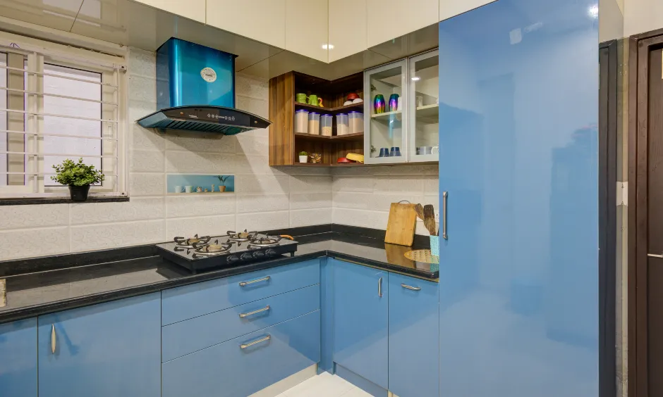 Modular kitchen in SR Preetham Residency 2BHK, Ameenpur with dual-tone blue cabinets and shelves.