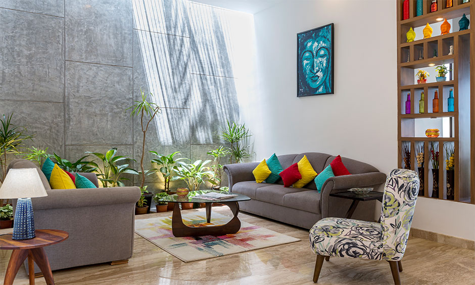 Mysore lounge with glass walls and lush greenery, showcasing the latest interior design trends.