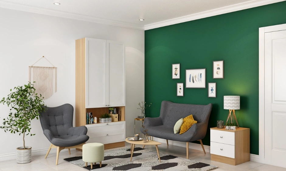Living room with a deep green TV wall, white seating, wooden storage and indoor plants.