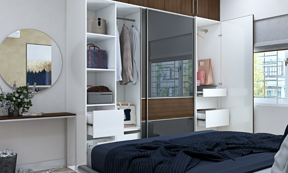 Large framed mirror in a compact minimalist bedroom reflecting light to create an expansive feel.