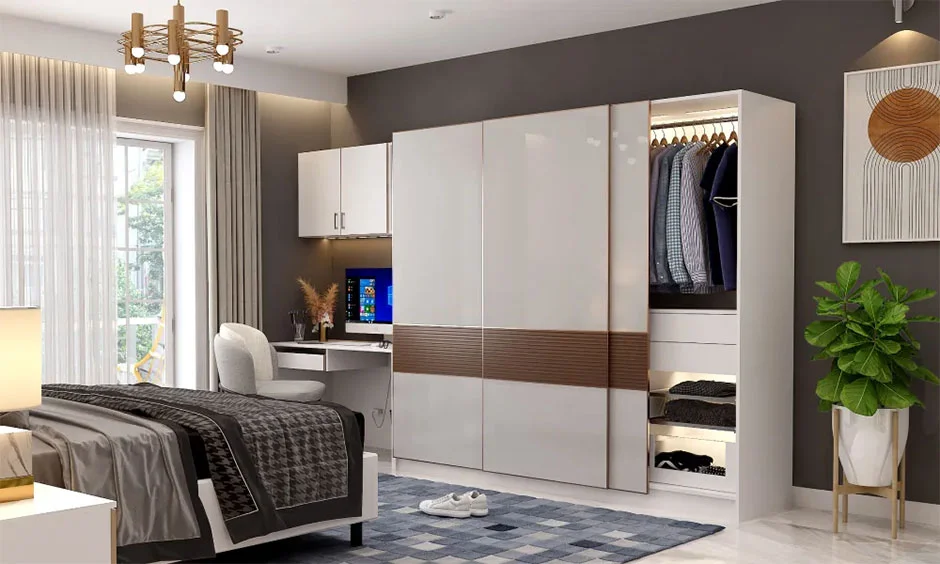 Interior design cost in Chennai with glossy white wardrobe shutters and light stone flooring in a bedroom.