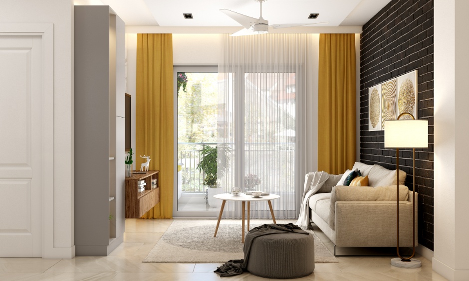 Bright 2BHK living room with balcony highlighting living room interior design cost in Noida