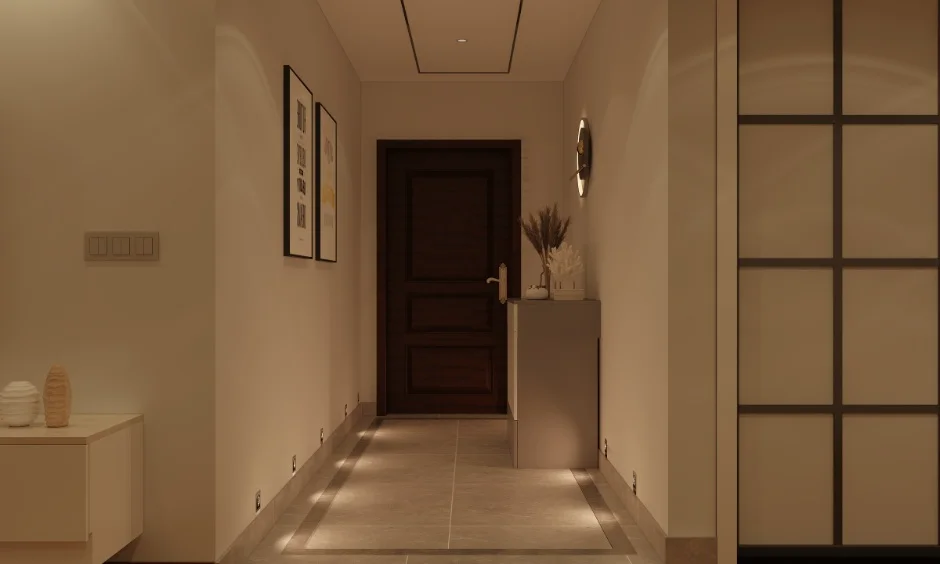 Foyer hallway with wooden door, wall art, and floor lighting in a 1 BHK interior home.