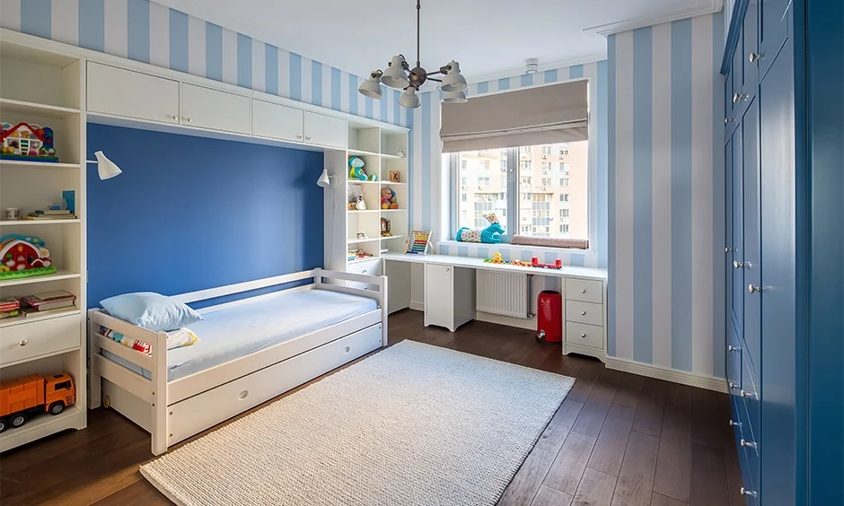 A compact bedroom uses built-in furniture and storage to maximise floor space. 