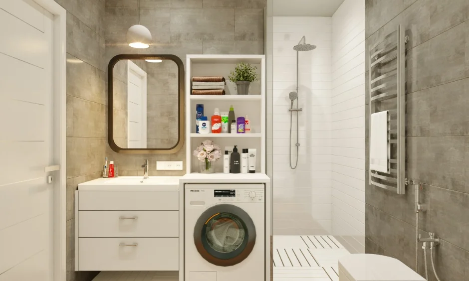A 1 BHK bathroom interior with a vanity, washing machine and shower area.