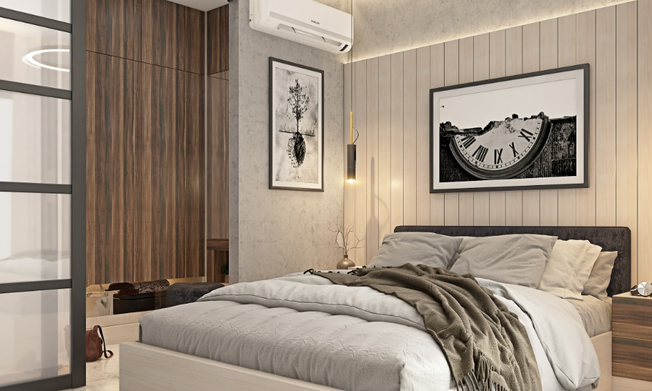 Modern 2BHK bedroom cost in Hyderabad featuring wood panelling, grey upholstered bed, bedside pendant light and warm layered lighting