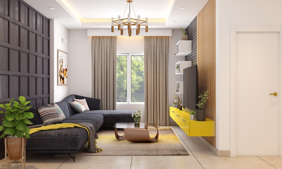 Modern 2BHK living room interior cost in Hyderabad featuring an L-shaped sofa, wall panelling, floating yellow TV unit and centre table