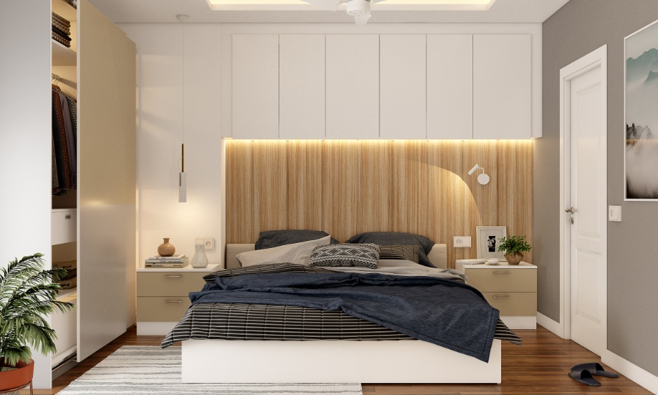 Modern 2BHK bedroom interior design cost in Hyderabad featuring a double bed, overhead cabinets, sliding wardrobe and wooden flooring