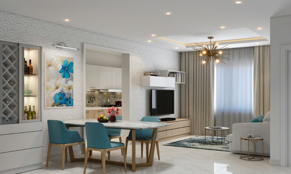 Modern 2BHK living and dining area interior in Hyderabad featuring a marble top dining table with blue chairs, wall-mounted TV unit and neutral sofa with full-length curtains