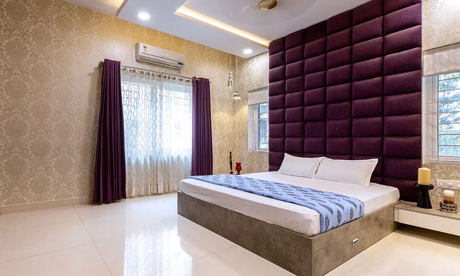 An upholstered headboard rises above the bed with enough height to clear stacked pillows.