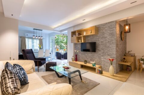 Vastu-inspired modern living room with greenery, warm lighting, and balanced décor.