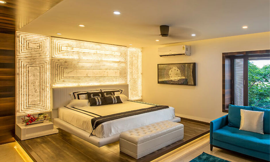 Latest bedroom wall design with indirect lighting for small rooms and layered lighting techniques for larger spaces.