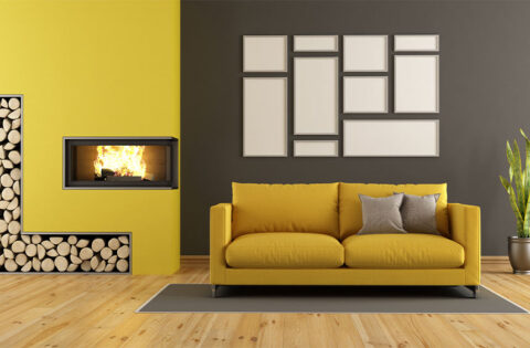 Bold accent wall with mustard sofa showing outdated interior design trends in modern homes