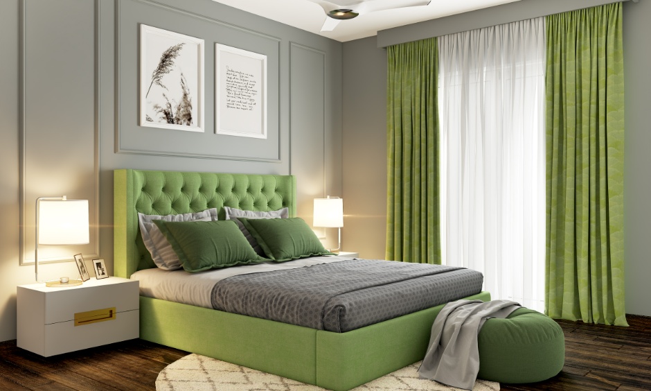 Light grey and sage green bedroom with soft lighting, layered bedding and a calm, cosy ambience