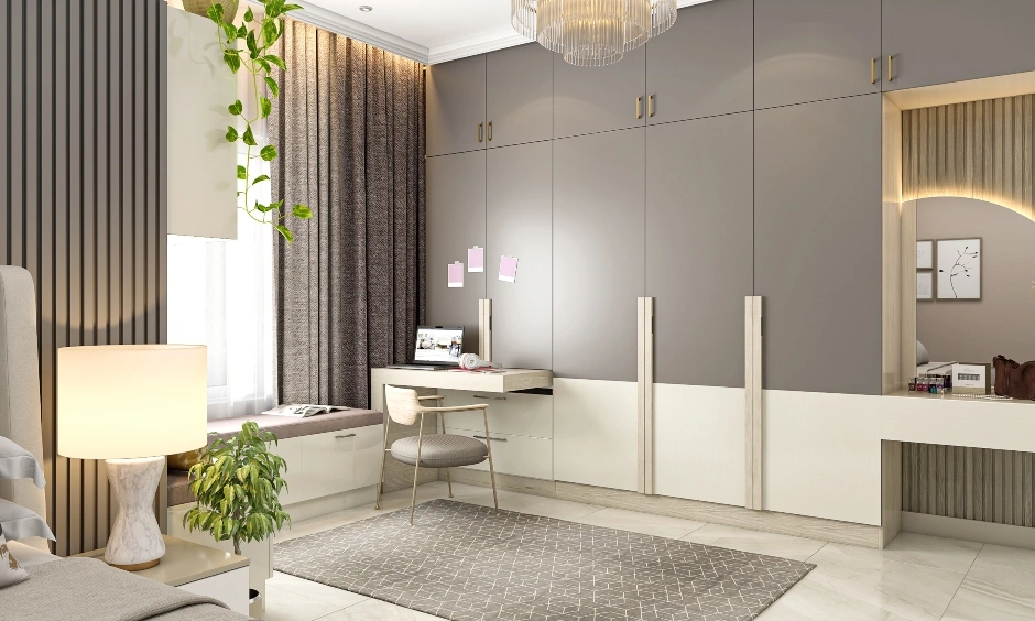 Modern floor-to-ceiling wardrobe with dual-tone shutters and vertical handles in an Indian bedroom.