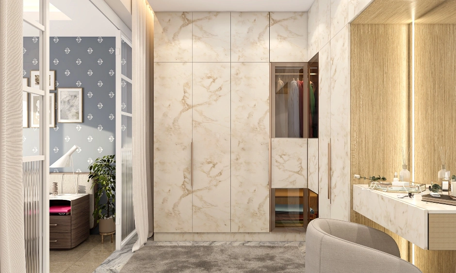 Luxury full-height bedroom marble finish wardrobe with tinted glass panels and gold handles in an Indian home.