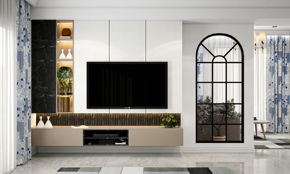 Modern living room design with arched black-framed partition and textured TV unit in an Indian apartment.