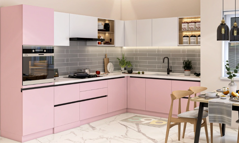 Modern L-shaped kitchen design with blush pink cabinets and dining setup for an Indian apartment.