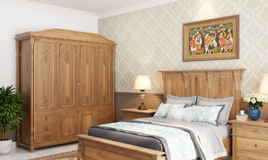 Traditional Kerala bedroom with wooden bed, neutral fabrics and natural ventilation.