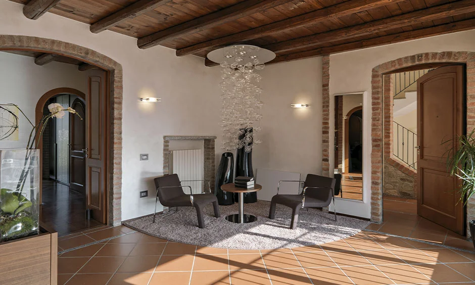 Warm lighting with brass lamps enhances woodwork in Kerala style interiors.