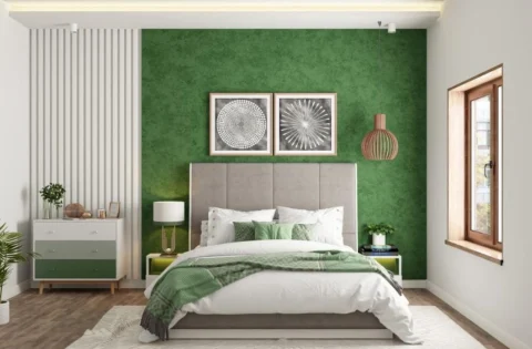 Bedroom with a rich green feature wall and warm brown wooden accents in a balanced colour scheme