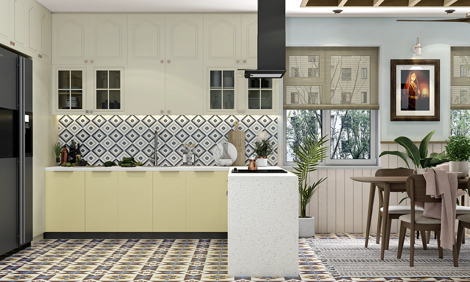 Eclectic L-shaped kitchen design with pale yellow cabinets and geometric patterned tiles in an Indian home.