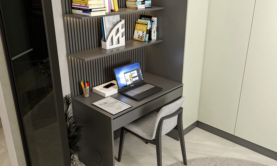Modern nook layout with wall-mounted desk, drawer storage and fluted panel in compact Indian apartment bedroom.