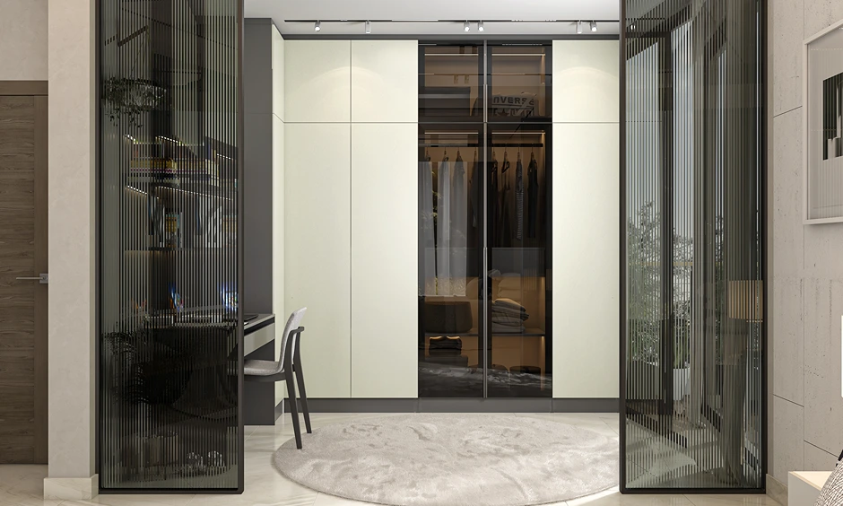 Contemporary bedroom corner with built-in wardrobe, open shelves and slim chair tucked under wall desk for clutter-free look.