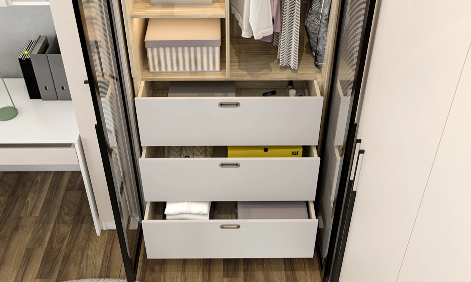 Interior view of a wardrobe featuring white pull-out drawers, wooden shelves, and organized clothing sections.