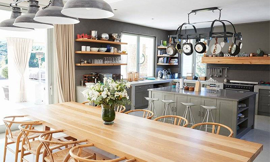 Open kitchen layout with dining space designed by a kitchen interior designer in Kolkata, which is beautiful and functional