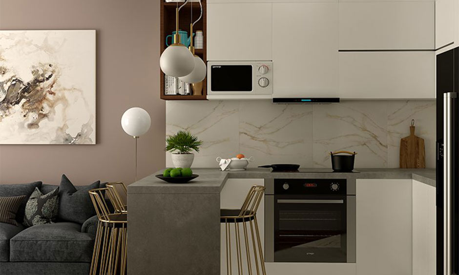 Open kitchen across the living room, designed by a kitchen interior designer in Kolkata, which makes the most of the limited space available