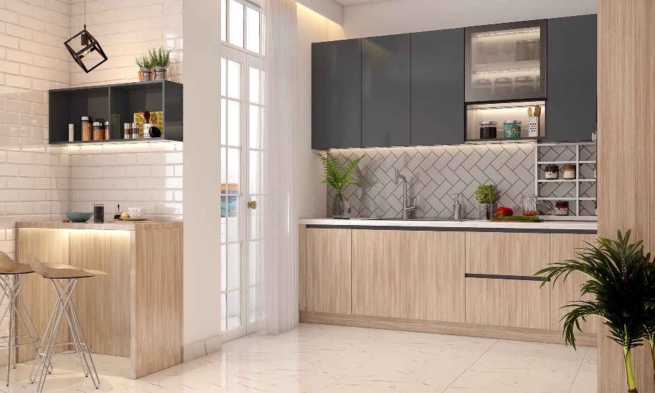 Space-saving modular kitchen in Kolkata with light wood cabinets, breakfast counter, tiled backsplash, and warm lighting.