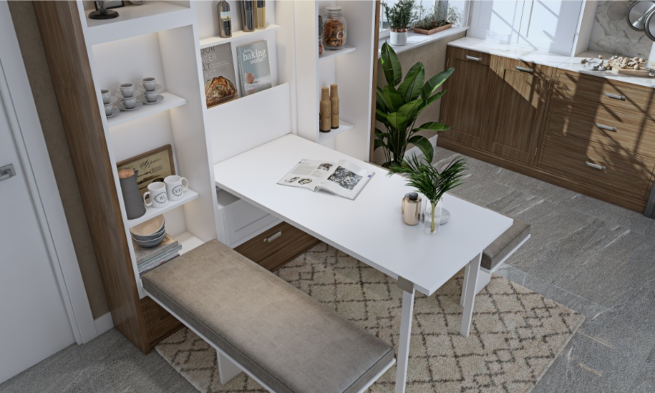 Wall-mounted dining table with hidden storage helps save space in a small apartment layout.