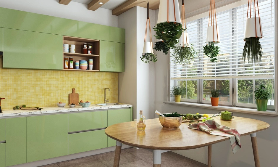 Bright green modular kitchen with tall storage units and ample natural light.