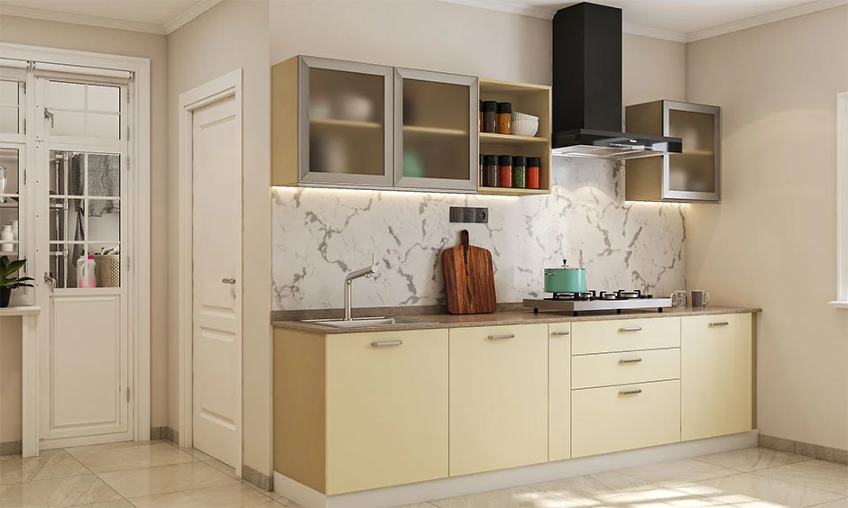 Warm blush cabinets and frosted glass define this sleek straight kitchen layout.