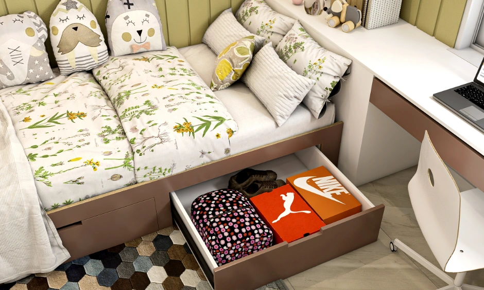 Close-up of a kids single bed featuring a large open underbed storage drawer with boxes inside.