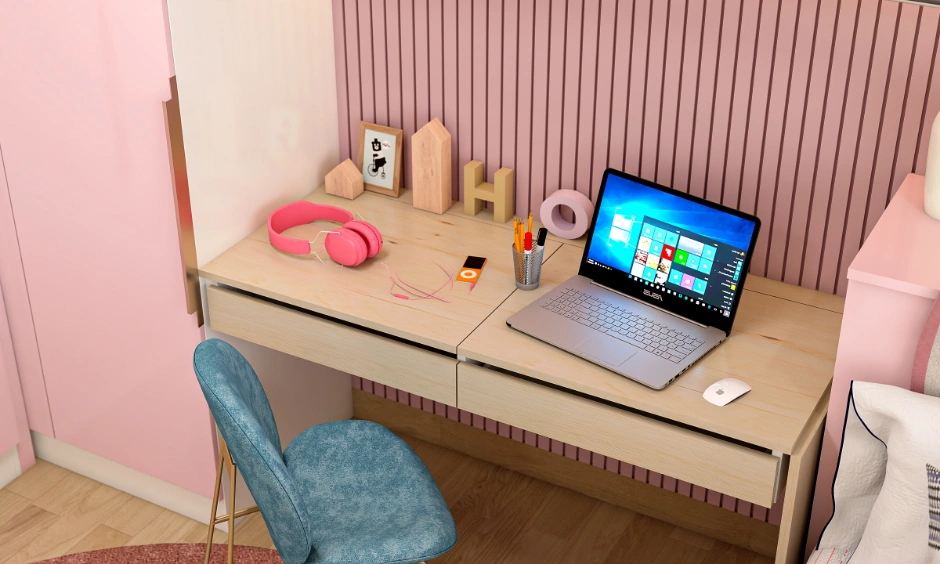 Wooden study desk in a kids bedroom designed with dual drawers and a pink fluted wall panel.