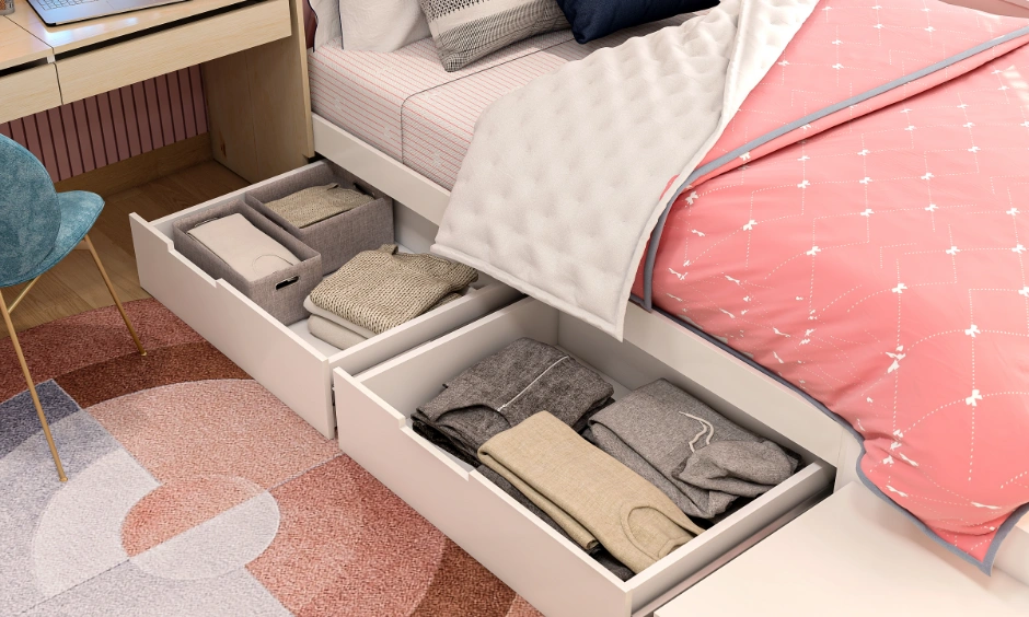 Kids bed with open underbed pull-out storage drawers filled with organized clothes.