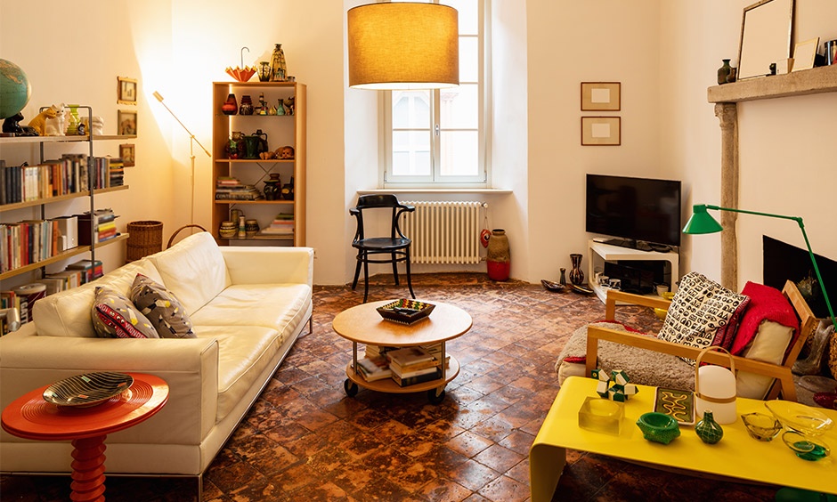 Terracotta feature wall adding warmth to a modern living room with natural materials.